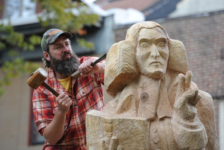 Wood carver Roger Wing, 47, of Powellton Village, is in his sixth and final week of turning an old Norway maple tree into the likeness of George Duffield, the first minister of Old Pine Street Presbyterian Church back in the Revolutionary War days. King George III put a bounty of 50 pounds on Rev. Duffield's head for preaching revolution against England. The tree is located in the graveyard next to the church building.