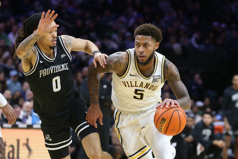 Justin Moore (right) of Villanova drives to the basket against Alyn Breed of Providence during the 2nd half on Jan.29, 2023 at the Wells Fargo Center.