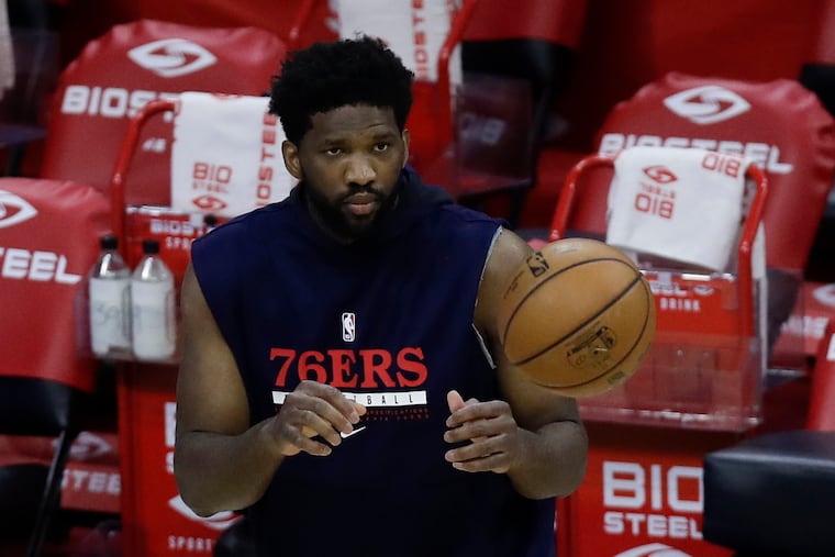 Sixers center Joel Embiid watches the basketball during warm-ups before the Sixers play the Minnesota Timberwolves on Saturday