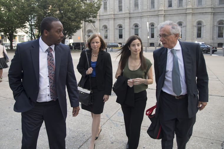 Plaintiff Bryant Miller (left) walks into Philadelphia City Hall in September with lawyers arguing for better school funding in Pennsylvania. The lawyers are Maura McInerney and, Deborah Gordon Klehr of the Education Law Center and Michael Churchill of the Public Interest Law Center.