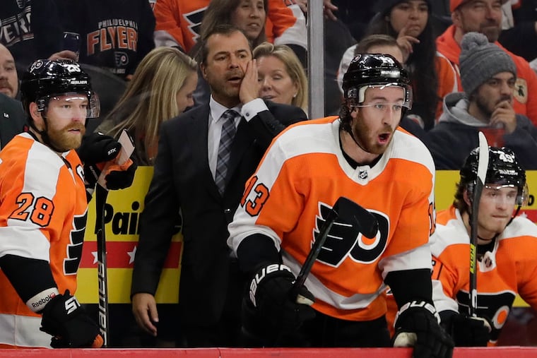 Flyers coach Alain Vigneault with captain Claude Giroux (left) and right wing Kevin Hayes during the game against the Columbus Blue Jackets on Oct. 26