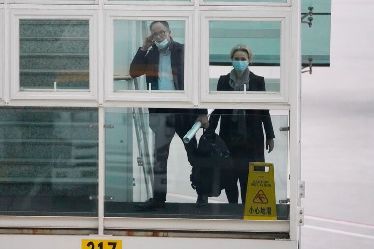 Peter Ben Embarek (left) and Thea Koelsen Fischer of the World Health Organization team prepare to board a plane from the tarmac at the airport to leave at the end of the WHO mission in Wuhan, China.