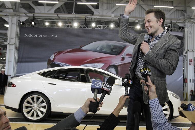 Tesla CEO Elon Musk shows off the latest moderl during a rally at the factory in 2012.