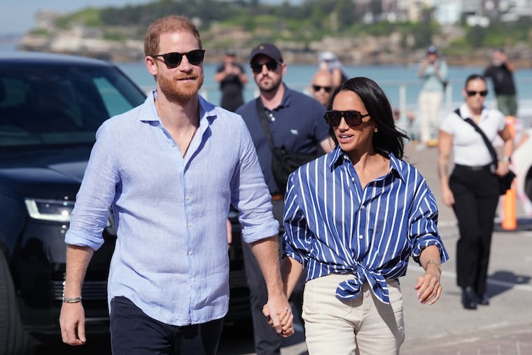 Prince Harry, and Meghan, the Duke and Duchess of Sussex, arrive for an event during a visit to Bondi Beach, Australia, on April 17.