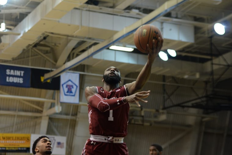 Redshirt senior Josh Brown goes up for a shot early in the first half of Sunday's La Salle vs. Temple game at the Gola Arena. GENEVA HEFFERNAN / Staff Photographer