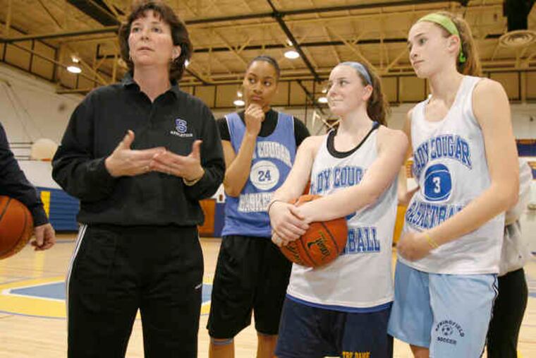 Springfield (Delco) coach Kim Smith makes a point to her players during practice. With a 21-0 record, a No. 1 seed and first-round bye, the Cougars will meet Oxford tomorrow in the Class AAA PIAA girls' basketball playoffs.