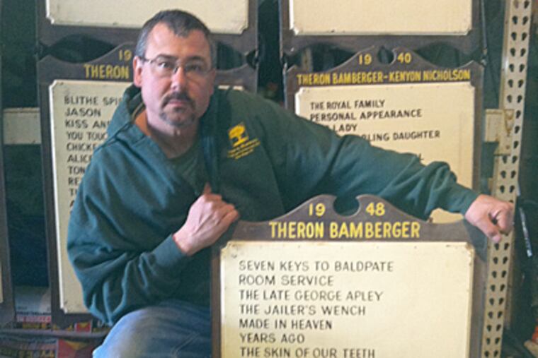 New Hope landscaper Hugh Marshall with some of the Bucks County Playhouse plaques he salvaged from trash bins after area's 2005 flood. (Bill Reed / Staff)