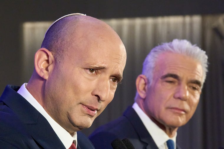 Former Israeli prime ministers Naftali Bennett (left) and Yair Lapid hold a joint news conference Sunday in Herzliya announcing that their parties will run together in the upcoming elections.