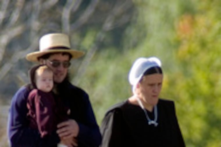 A family arrives for a gathering yesterday at a farm along Mine Road in Lancaster County.
