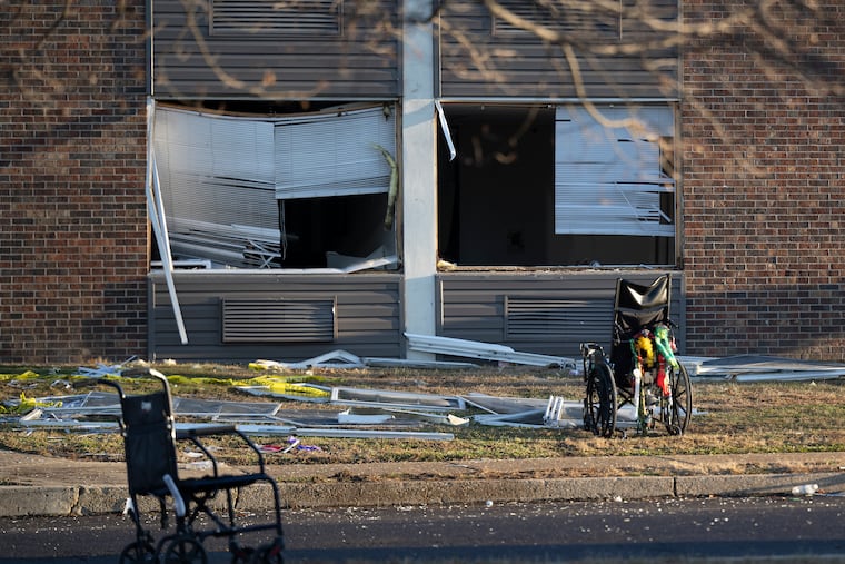 Wheelchairs and other debris are scattered amid structural damage at Bristol Health & Rehab Center on Wednesday.