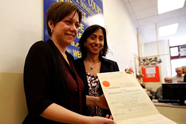 Kerry F. Smith (left) and Rue Landau hold their marriage certificate at the marriage bureau office in City Hall on Tuesday, May 20, 2014. They intend to get married next Tuesday. ( Yong Kim / Staff Photographer )