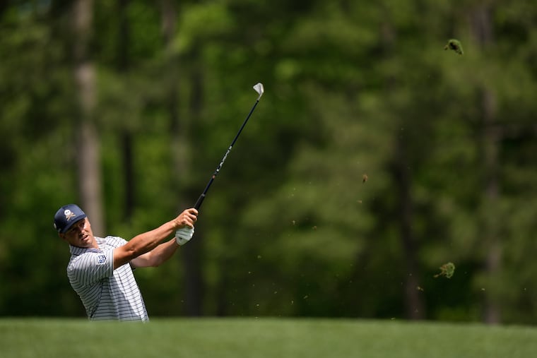 Bryson DeChambeau watches his tee shot on the 12th hole during the first round at the Masters. DeChambeau was in the lead when the play was suspended because of darkness.