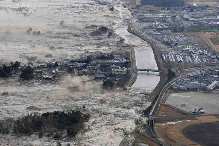 Above, 13-foot tsunami waves, triggered by an 8.9 earthquake, sweep boats, cars and tons of debris in Iwanuma in northern Japan yesterday. At right, buildings blaze in the city of Yamada.