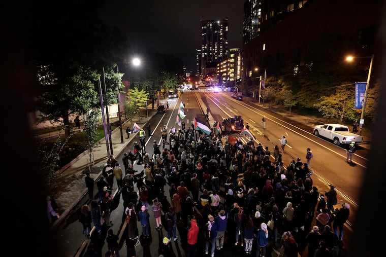 Pro-Palestinian activists march north on 38th St., towards Walnut St., in the University City section of Philadelphia on Friday.