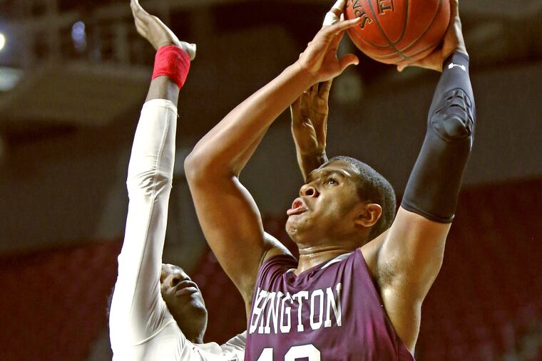 Abington forward Eric Dixon makes his move to the basket past Plymouth Whitemarsh center Naheem McLeod.