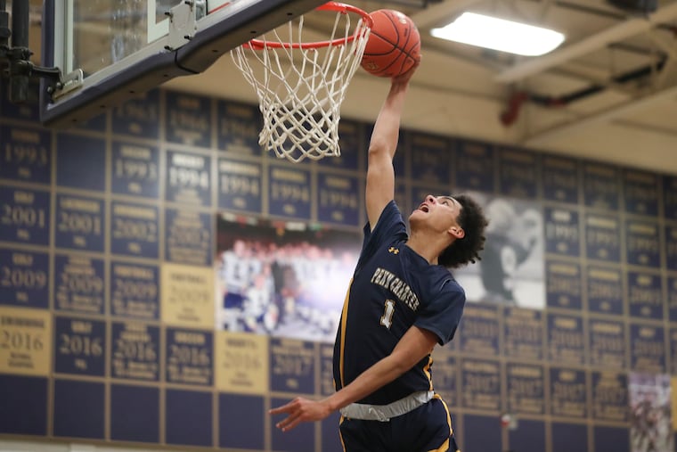 Kai Shinholster of Penn Charter goes up for a dunk last season against La Salle College High School.