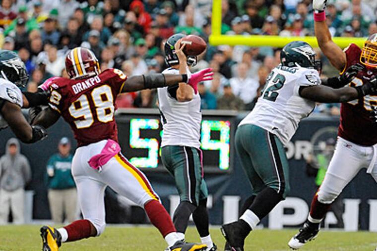 Kevin Kolb stands in the pocket and throws a long completion. (Clem Murray / Staff Photographer)