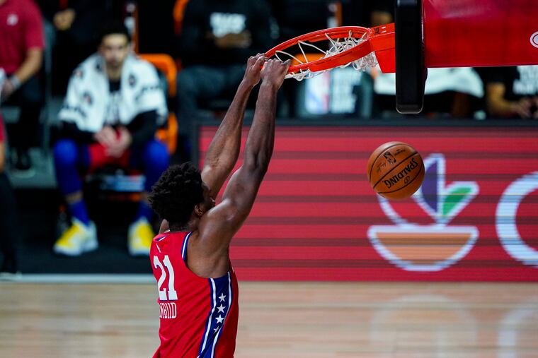 Joel Embiid gets a dunk against the Washington Wizards during the second half.