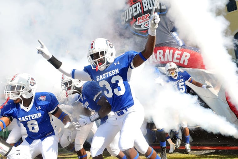 The Northwest Raiders enter the field before winning the "Midget" division of the Pop Warner National Super Bowl Championship at Walt Disney World. (Gerardo Mora/IPAPhoto.com)