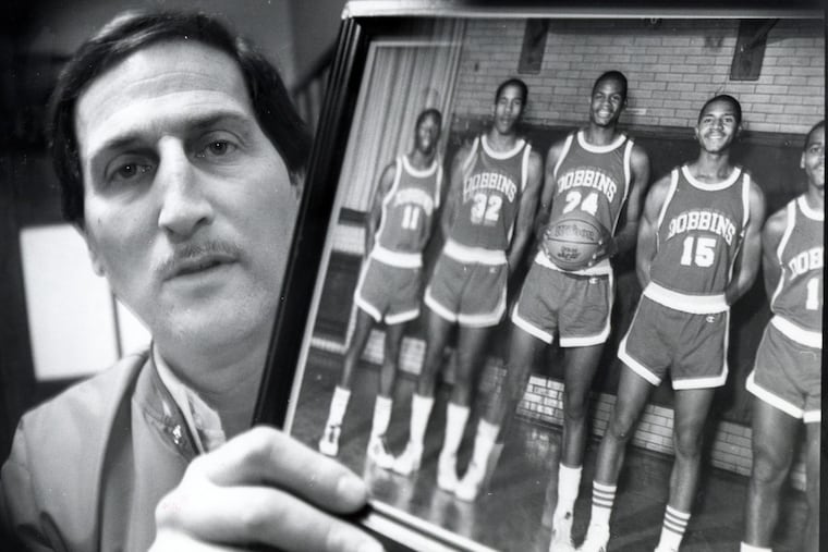 Rich Yankowitz displays a photo of his 1984-85 Public League championship basketball team that featured Bo Kimble (32) and Hank Gathers (24).