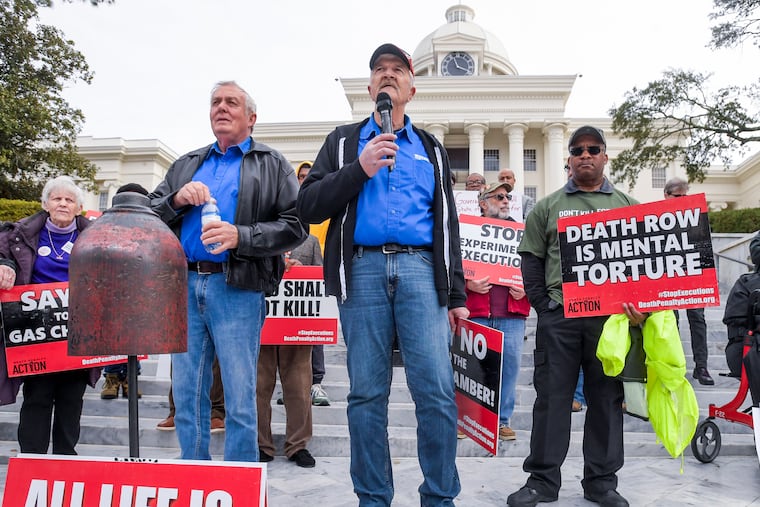 Former death row inmates who were exonerated, (from left) Randall Padgent, Gary Drinkard, and Ron Wright, were among the nearly 100 demonstrators gathered at the state Capitol building in Montgomery, Ala., to protest the planned execution of Kenneth Eugene Smith.