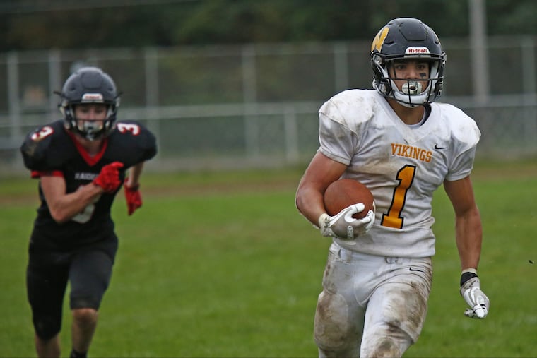 Archbishop Wood's Tom Santiago rips off a big fourth-quarter gain with Archbishop Ryan's Justin Collier giving chase.