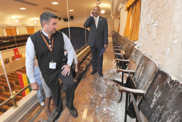 Assessing water damage in the Furness High auditorium in South Phila. are principal Tim McKenna (left) and teachers' union chief Jerry Jordan. (April Saul / Staff Photographer)