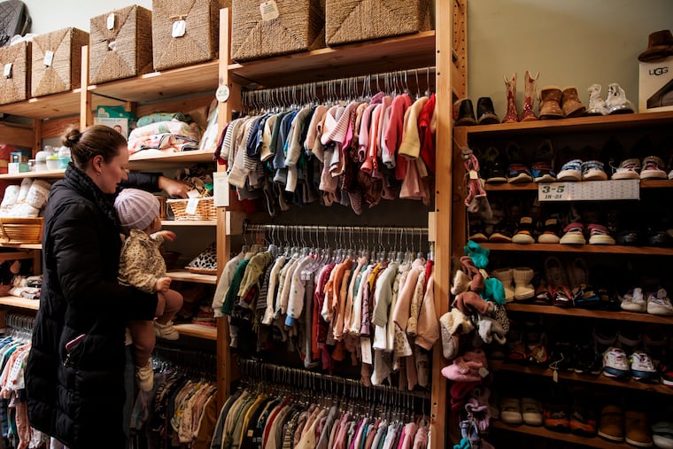 Laura Alalay shops with Rose, 10 months, of Queen Village, at the Nesting House in Philadelphia. The Nesting House sells both new and used children's clothing and items.