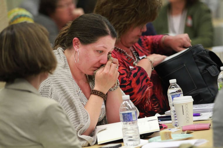 Julie Gandy (center), representing the Unitarian Universalist Church in Cherry Hill, was overwhelmed by emotion at the daylong Camden Trauma Summit at Cooper Medical School of Rowan University. "Camden is a place of pain," one organizer said.