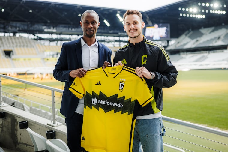 Former Union midfielder Dániel Gazdag (right) officially joined the Columbus Crew on Friday, and was given his new jersey by general manager Issa Tall (left).