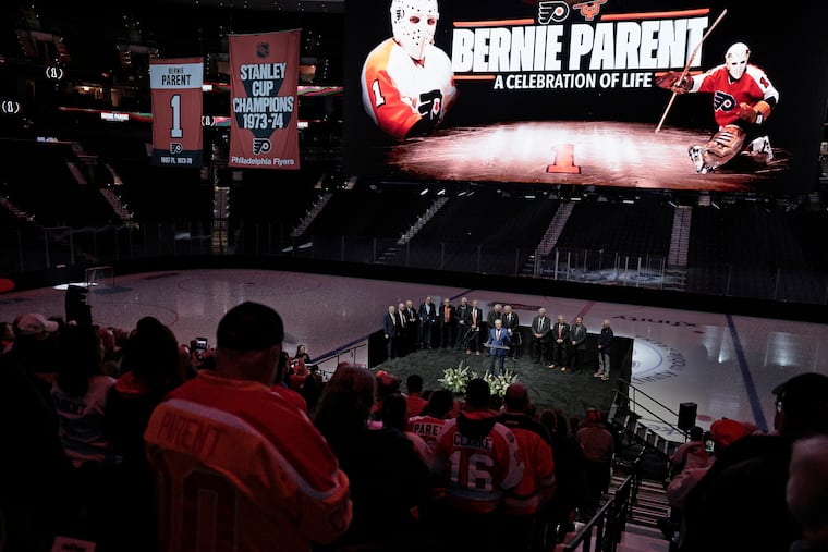 Former teammates of Bernie Parent take the stage as Bill Clement speaks during the Bernie Parent Celebration of Life at Xfinity Mobile Arena on Friday.