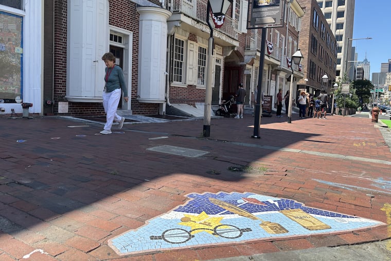 A vinyl mosaic decal just outside of Franklin Court in Old City marks the site as a stop on the Path to Democracy during the trail's beta testing phase. A QR code on the decal takes visitors to an accompanying website about Franklin Court and the path itself.
