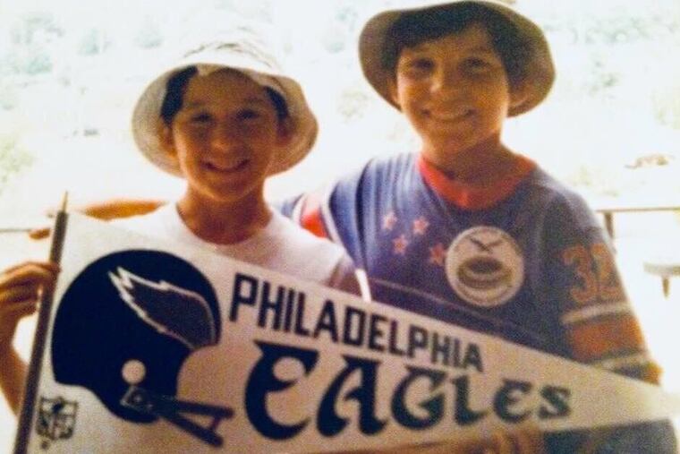 The author’s brothers, Teddy and Jon Flowers, at an Eagles game many years ago.