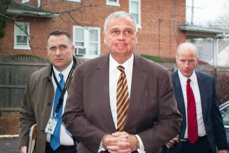 Here, Kerns, dressed in a brown suit, stripped tie and handcuffs is escorted to his arraignment before Judge Robert Sobeck by Montco detectives. ( ED HILLE / Staff Photographer )