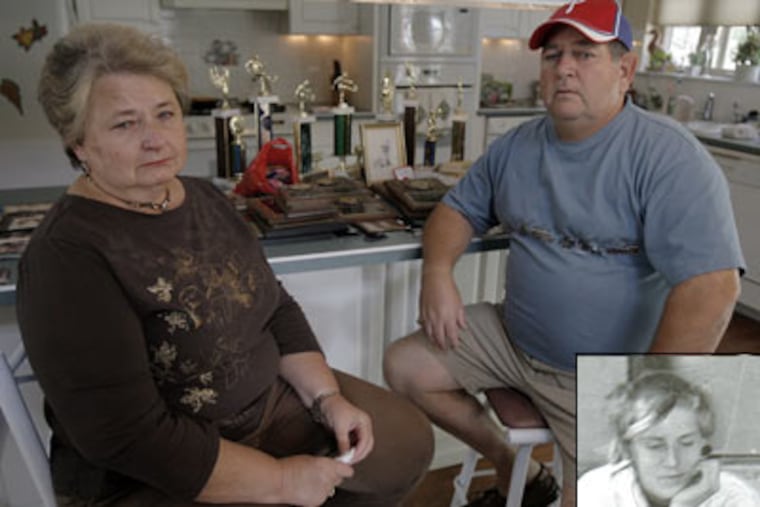 Tim Bradly's parents, Peg and Tom, with their son's sports trophies from his active youth. (Akira Suwa / Staff Photographer)