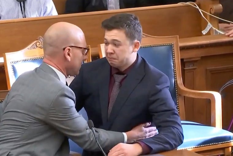 Kyle Rittenhouse is comforted by his lawyer as he was acquitted of all charges at the Kenosha County Courthouse in Kenosha, Wis., on Friday, Nov. 19, 2021. The jury came back with its verdict after close to 3 1/2 days of deliberation.