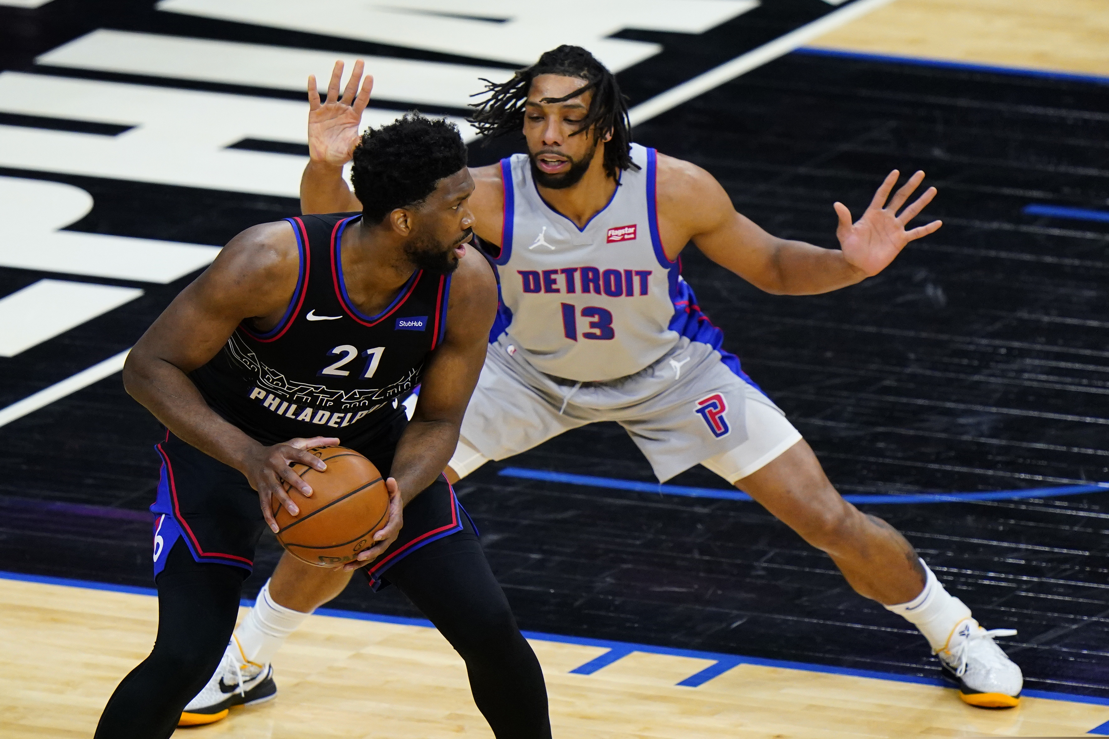 76ers center Joel Embiid tries to get around Detroit's Jahlil Okafor during the first half Saturday.