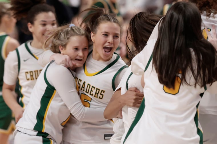 Lansdale Catholic players, including Gabby Casey (right), celebrate after winning the Class 4A girls' basketball championship Saturday at the Giant Center in Hershey.