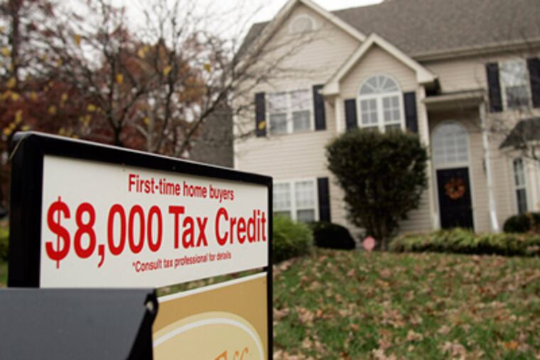 A sign offering a government tax credit for first-time buyers stood outside a home last year in Raleigh, N.C. (Jim Bounds / Bloomberg News)