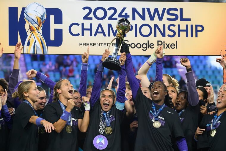 Marta (center) and goal-scorer Barbra Banda (second from right) celebrate with the trophy after Orlando's title win.