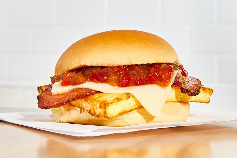 The breakfast sandwich from Federal Donuts includes steamed and fried egg, Cooper sharp cheese, bacon, and cherry pepper relish on a Martin's potato roll.