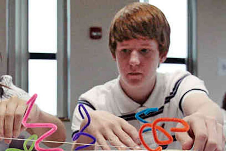 Stacy Wong (not pictured) and Patrick Gorman, both 17, show off the BabyBach,their musical innovation.