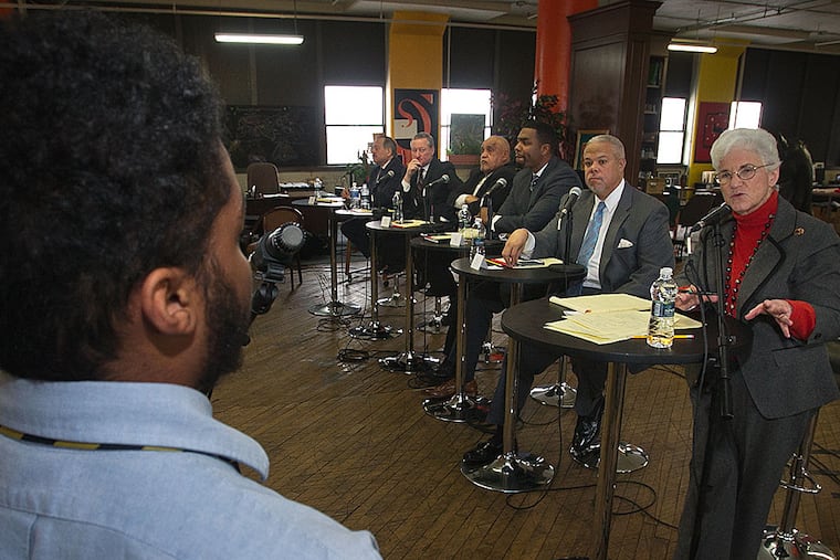 Romao Algarin, 16, an 11th-grader at KIPP Charter School, asks a question of the candidates.