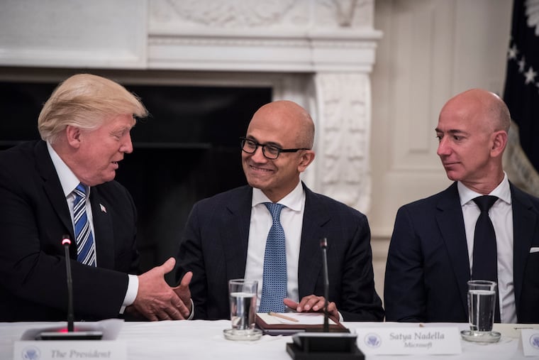 President Donald Trump greets Microsoft CEO Satya Nadella (center) and Amazon founder and Washington Post owner Jeff Bezos at the White House in 2017. “The first term, everybody was fighting me,” Trump said in remarks at Mar-a-Lago. “In this term, everybody wants to be my friend.”