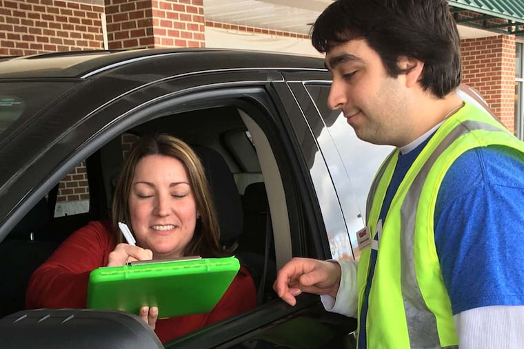 After Marlene Bower completes her grocery pickup, Graham Simon has her sign off. "I love it," says Bower. "Especially when it's cold - I don't have to get out of my car."