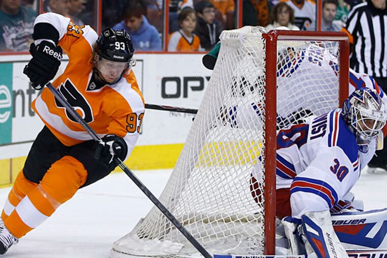 Rangers' Henrik Lundqvist, right, blocks a shot by Flyers' Jakub Voracek. (Matt Slocum/AP)