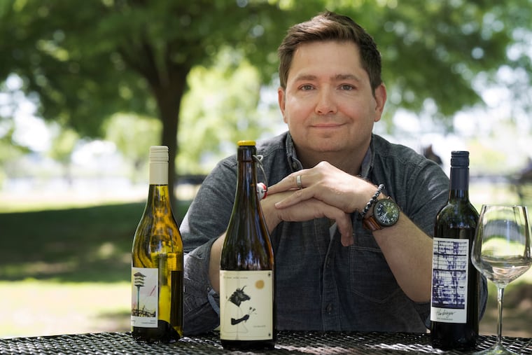 Corey Krejcik of Thirsty Bandit Co. poses with a selection of wine and vermouth bottles on Monday in Philadelphia.