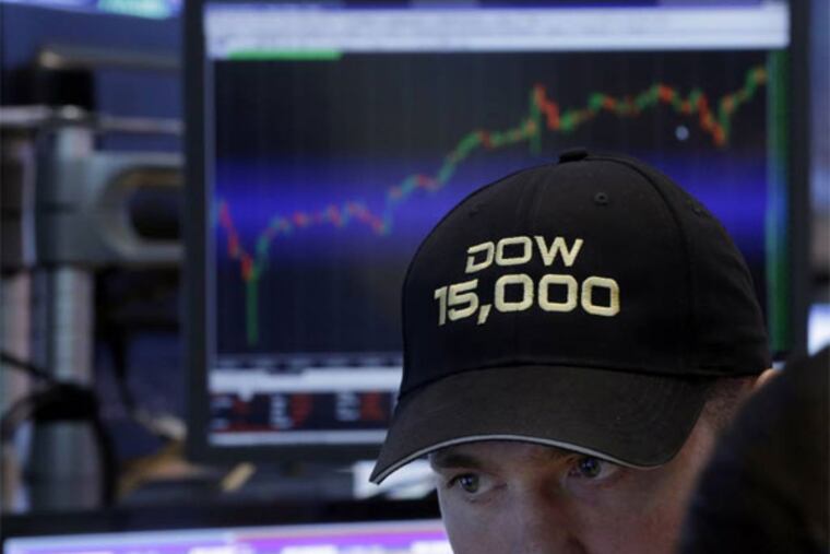 FILE - In this Friday, May 3, 2013, file photo, a specialist wears a "Dow 15,000" hat as he works at his post on the floor of the New York Stock Exchange, as a big gain in the job market is lifting the stock market to a record high. The stock market surged, traders donned party hats, and the wave of buying drove three indexes through major milestones in 2013. (AP Photo/Richard Drew, File)