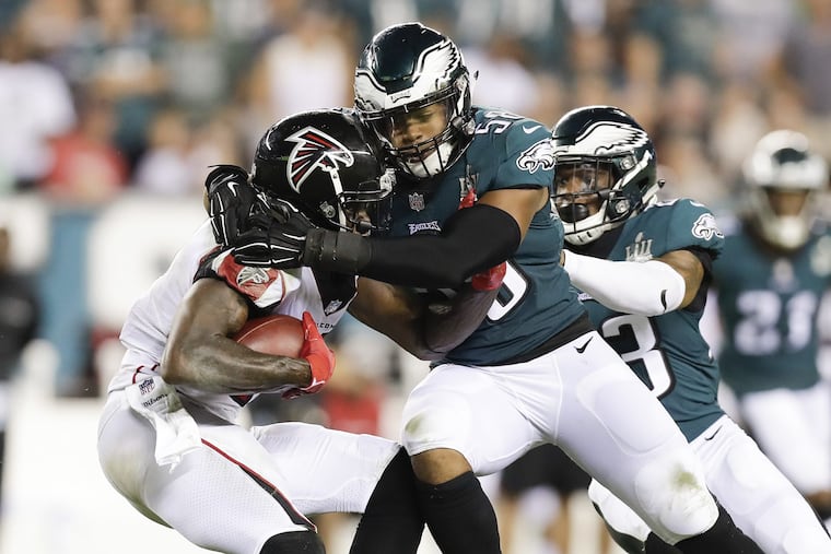 Jordan Hicks stops Falcons wide receiver Julio Jones during the Eagles' season-opening win on Thursday. The Eagles' defense will be tested this week in Tampa Bay.