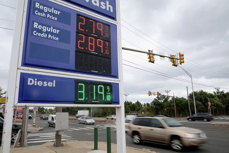 Traffic passes by a vacant lot (rear) that developer Bart Blatstein hopes to turn into a Wawa gas station at South Christopher Columbus Boulevard and Tasker Street in South Philadelphia on Friday, Sept. 13, 2019. In order to get around a restriction against gas pumps along South Columbus Boulevard, Blatstein carved a narrow strip of the property into a separate parcel, angering some community members. The sign in the foreground advertises prices for an existing gas station nearby.